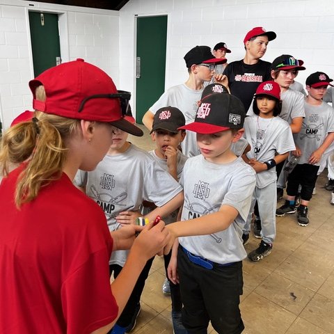 Kids lining up to get their hands stamped